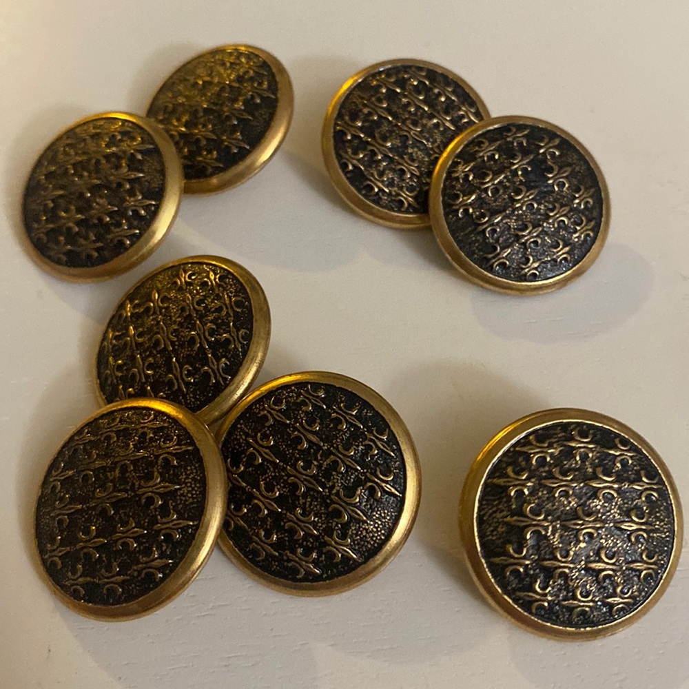 Metal fleur-de-lis embossed buttons is